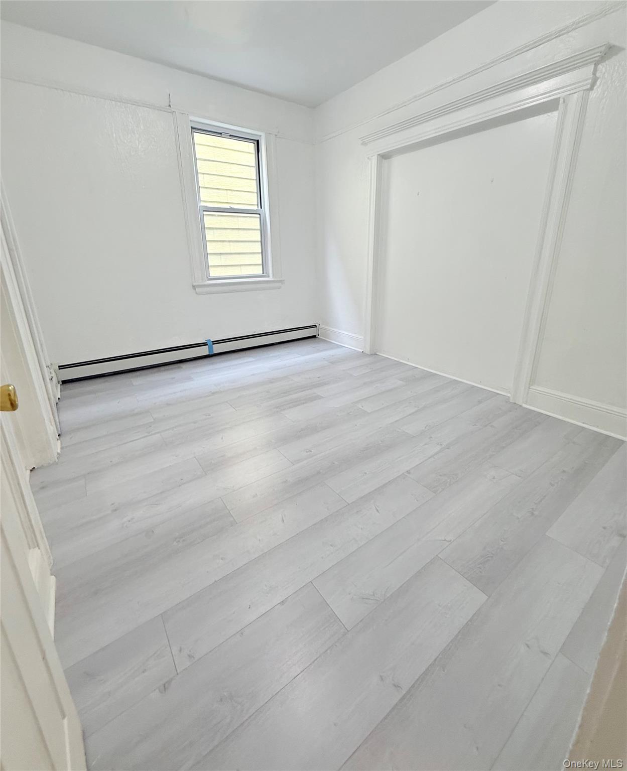 88-08 88th Street Queens, NY 11421 - Photo 17 of 32 an empty room with windows