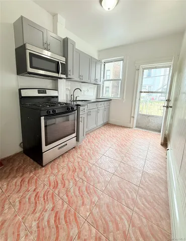 a kitchen with a stove a microwave and a sink