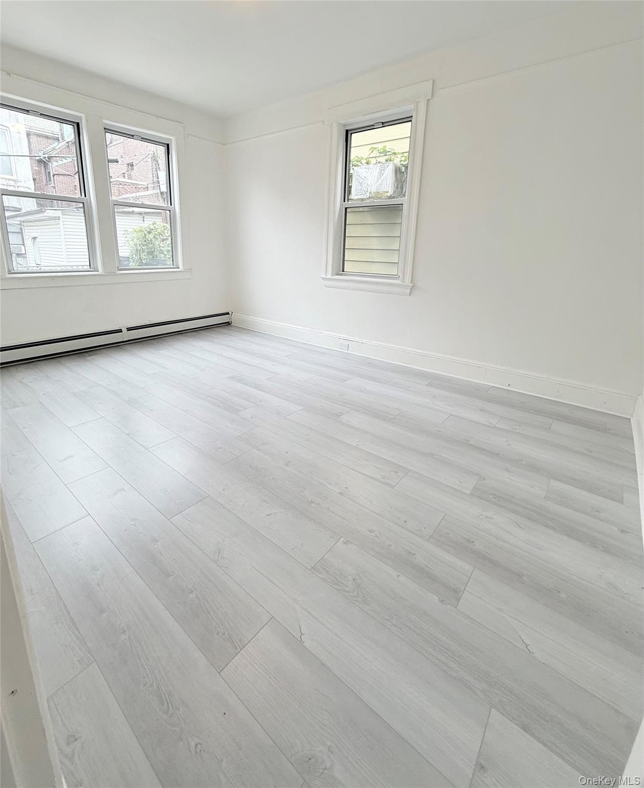 88-08 88th Street Queens, NY 11421 - Photo 2 of 32 an empty room with windows