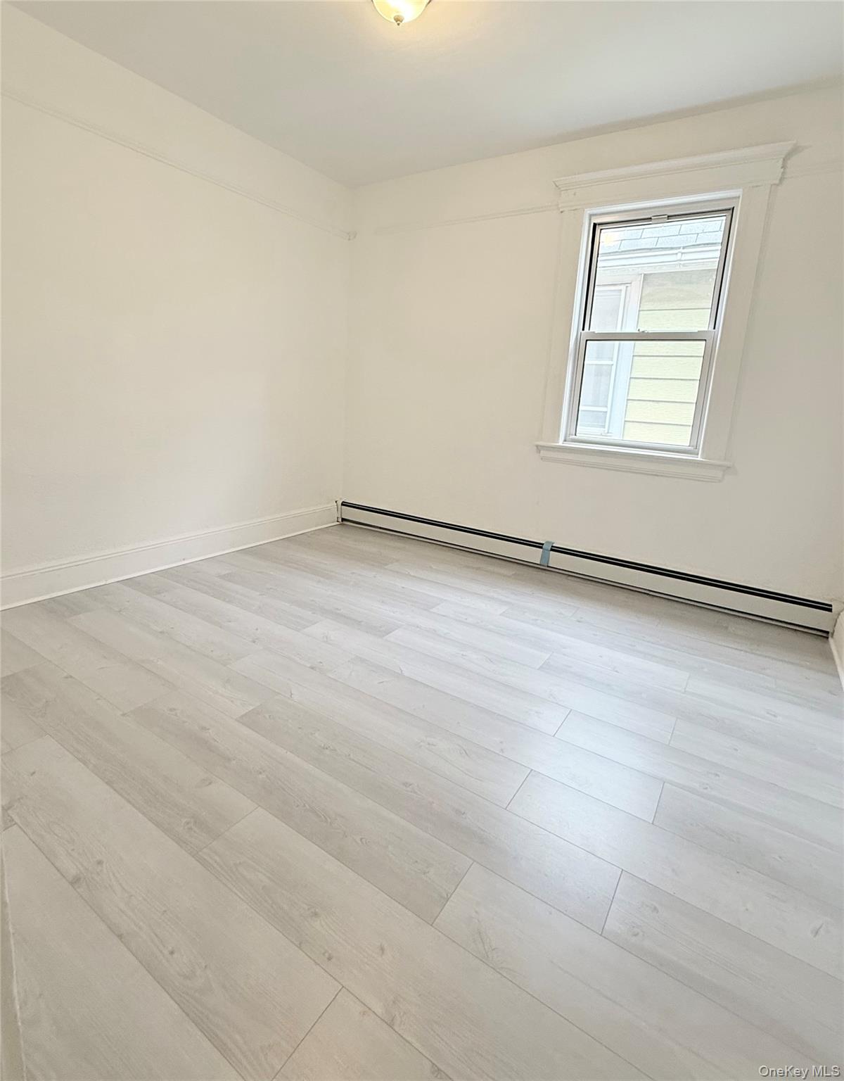 88-08 88th Street Queens, NY 11421 - Photo 25 of 32 an empty room with a workbench