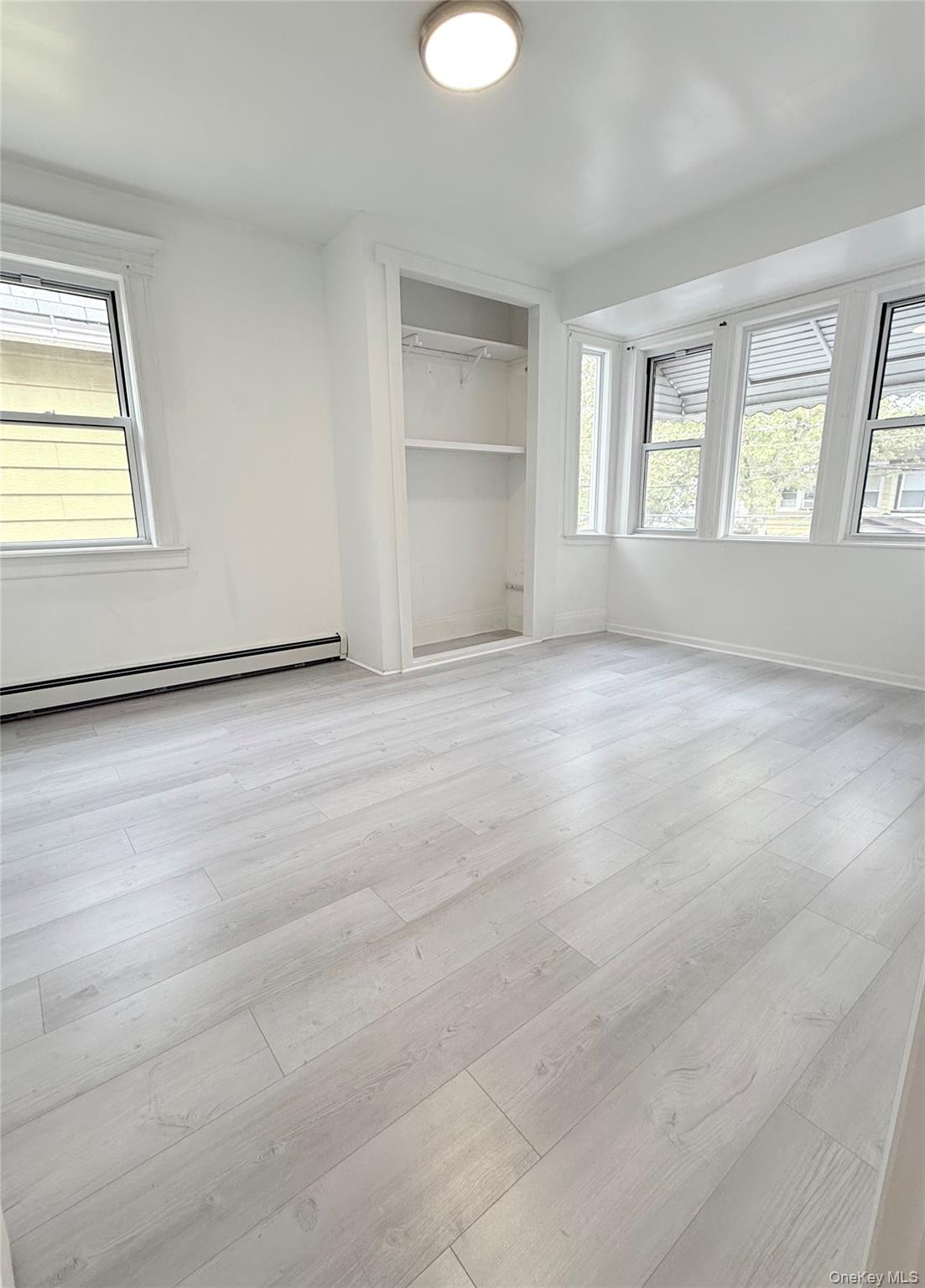 88-08 88th Street Queens, NY 11421 - Photo 26 of 32 an empty room with windows and closet