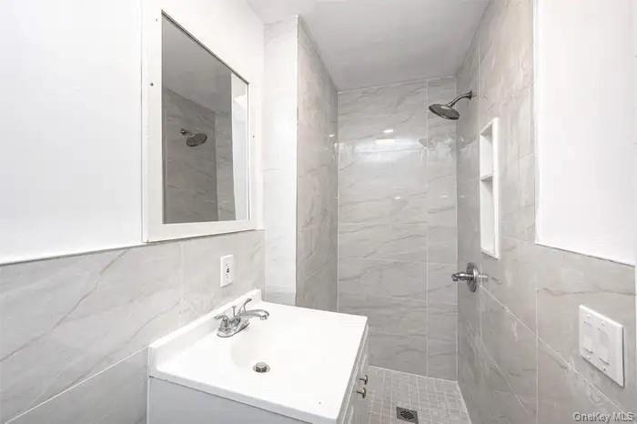 88-08 88th Street Queens, NY 11421 - Photo 30 of 32 a bathroom with a sink and shower