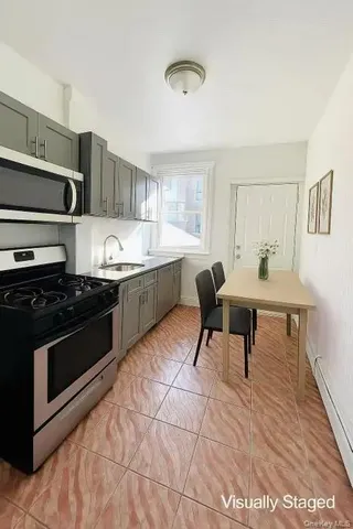 a kitchen with stainless steel appliances kitchen island granite countertop a sink and cabinets