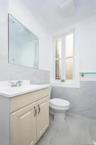 a bathroom with a sink toilet and mirror