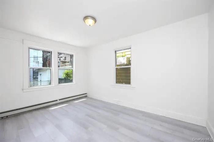 88-08 88th Street Queens, NY 11421 - Photo 9 of 32 an empty room with windows