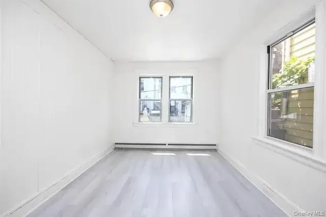 an empty room with windows and entrance