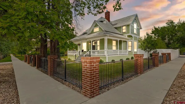 a front view of a house with iron fence