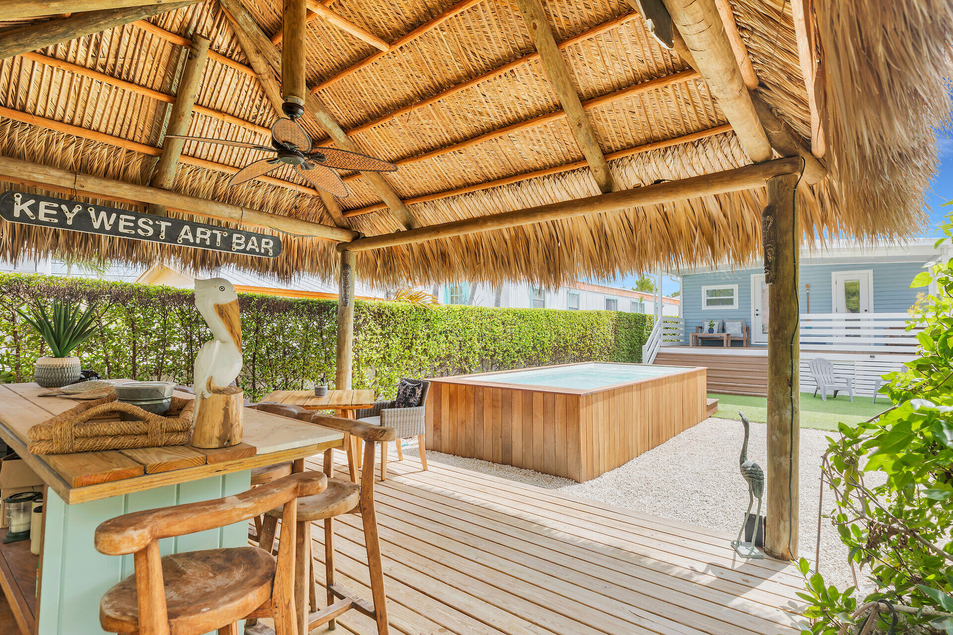 553 Oldsmar Lane Key Largo, FL 33037 - Photo 2 of 48 a view of a patio with table and chairs a barbeque with wooden floor and fence