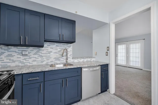 a kitchen with granite countertop stainless steel appliances granite countertop wooden cabinets and a granite counter tops