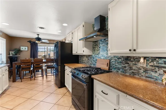 a kitchen with granite countertop a sink stove and cabinets