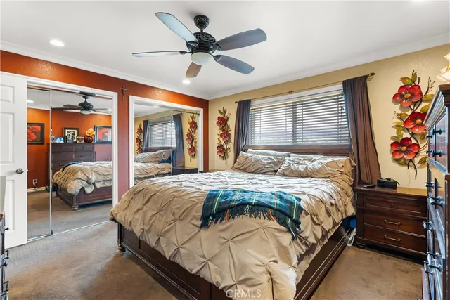 a bedroom with a bed and a large mirror