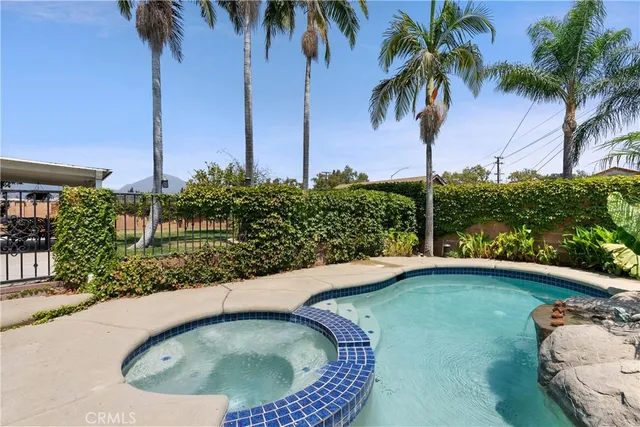 a view of a backyard with swimming pool
