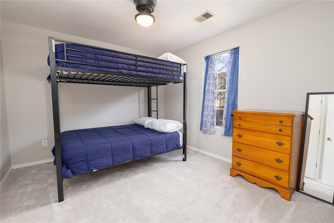 410 South Cove Road Seneca, SC 29672 - Photo 17 of 25 This cozy bedroom features a bunk bed and soft carpeting, creating a comfortable living space.