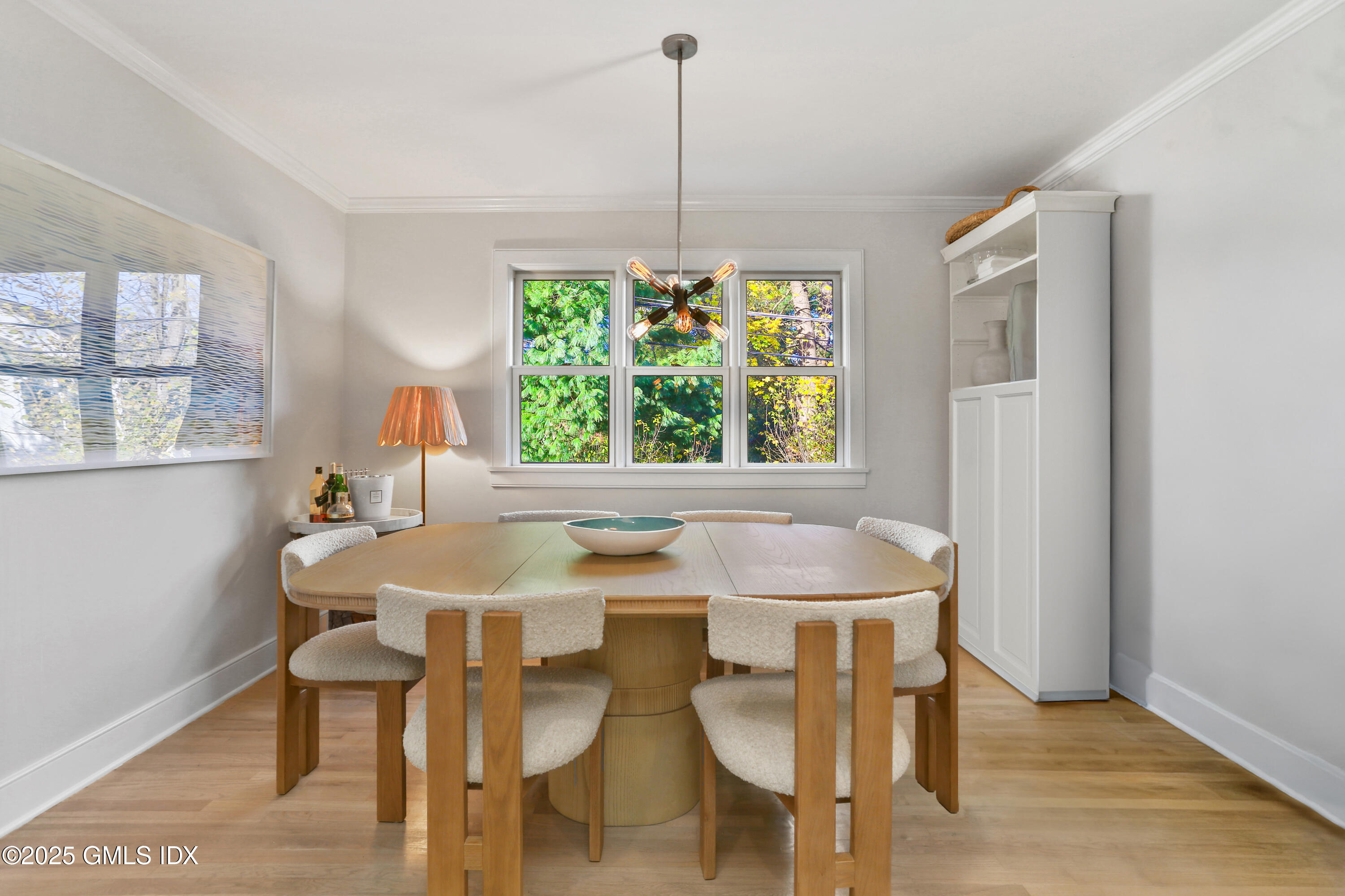 6 Meadowbank Road Old Greenwich, CT 06870 - Photo 11 of 30 a dining room with furniture a chandelier and wooden floor