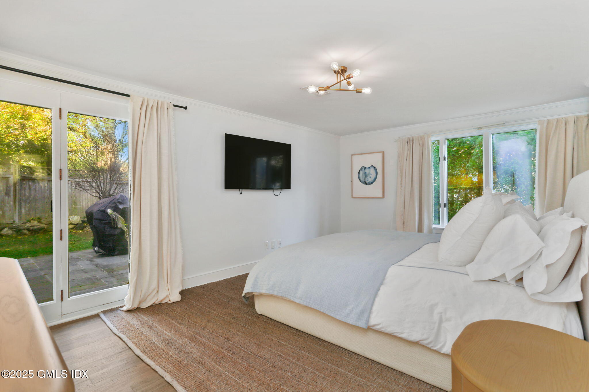 6 Meadowbank Road Old Greenwich, CT 06870 - Photo 12 of 30 a bedroom with a large bed and a flat screen tv