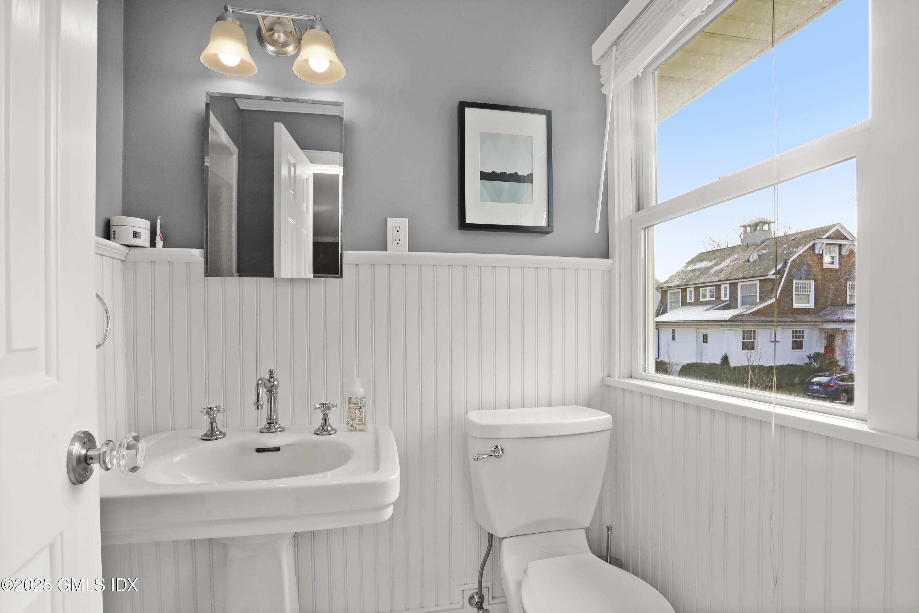 6 Meadowbank Road Old Greenwich, CT 06870 - Photo 15 of 30 a bathroom with a toilet a sink and a mirror