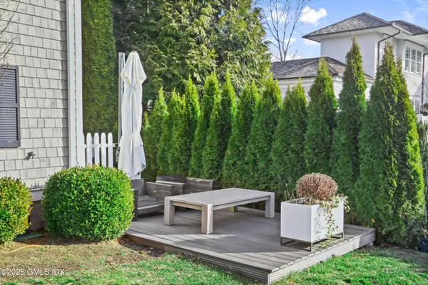 a view of a chairs and table in back yard of the house