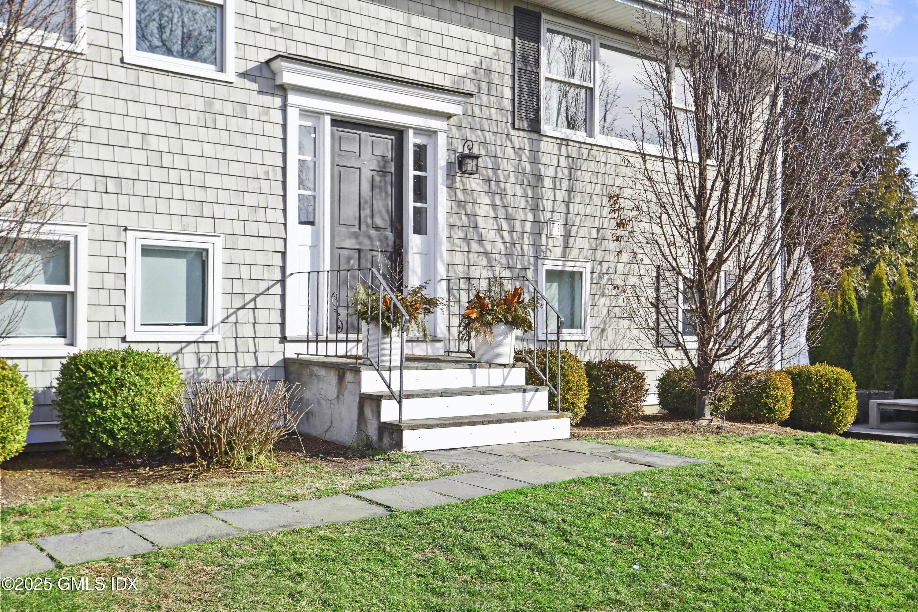 6 Meadowbank Road Old Greenwich, CT 06870 - Photo 25 of 30 a front view of a house with a yard