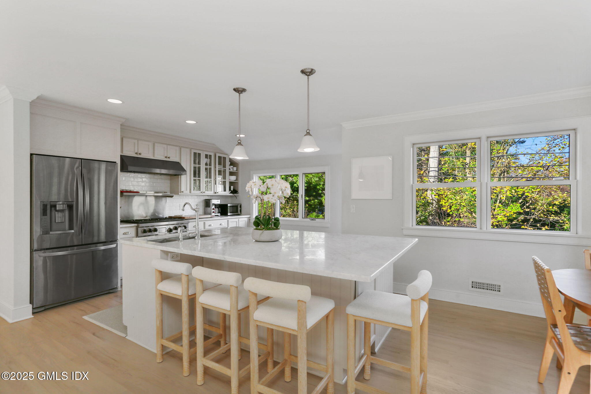 6 Meadowbank Road Old Greenwich, CT 06870 - Photo 4 of 30 a kitchen with stainless steel appliances granite countertop a refrigerator a sink a stove a dining table and chairs