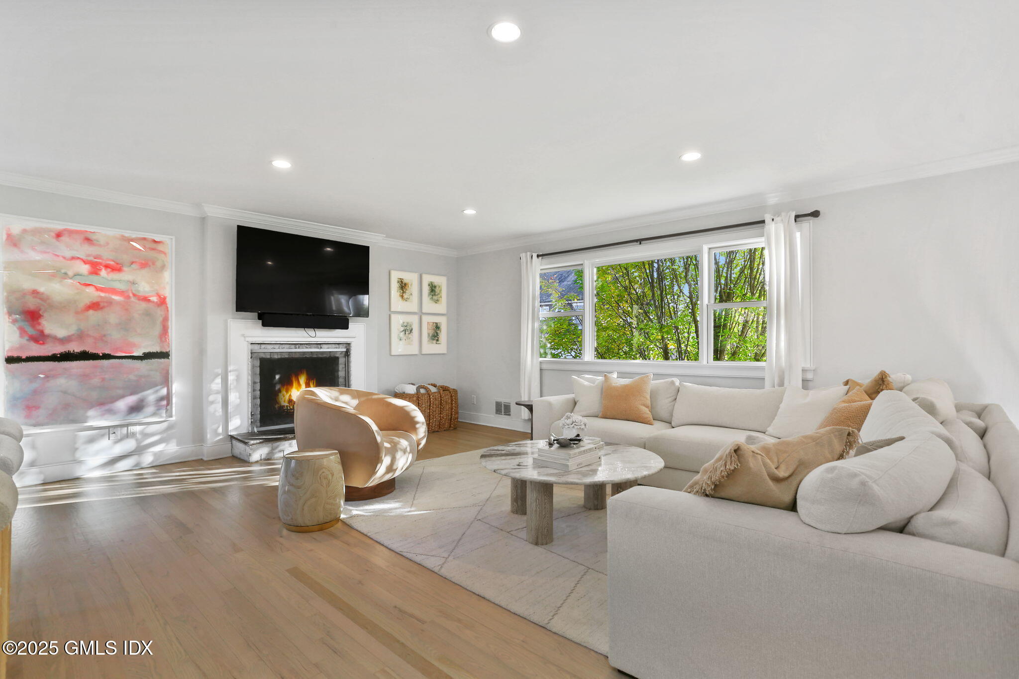 6 Meadowbank Road Old Greenwich, CT 06870 - Photo 7 of 30 a living room with furniture a fireplace and a flat screen tv