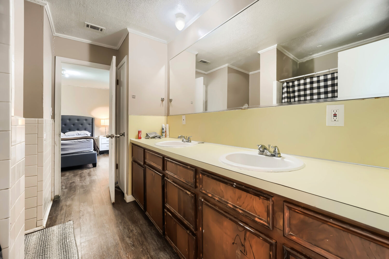 14520 Bois-D-Arc Road Manor, TX 78653 - Photo 8 of 21 a en suite bathroom with a sink a mirror and a shower