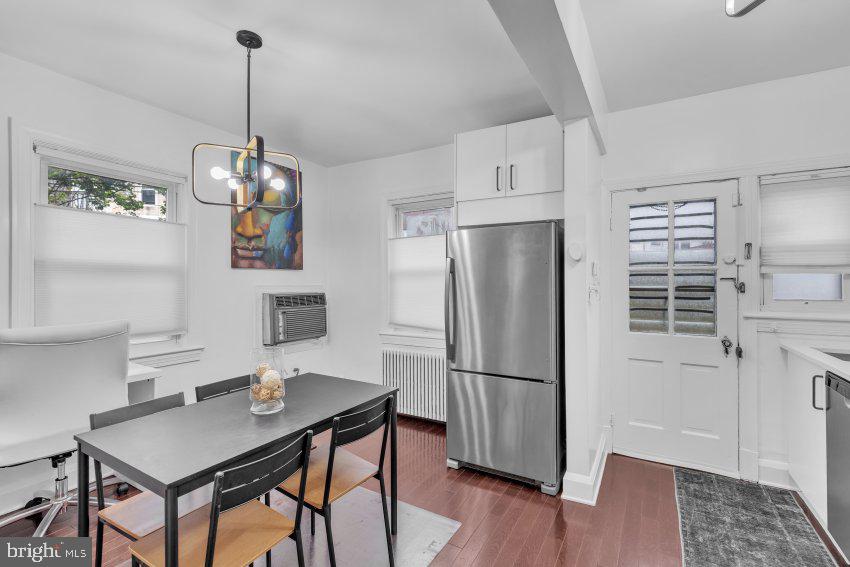 3310 Elbert Street Baltimore, MD 21229 - Photo 12 of 23 a kitchen with stainless steel appliances a refrigerator a sink a stove a microwave and dining table