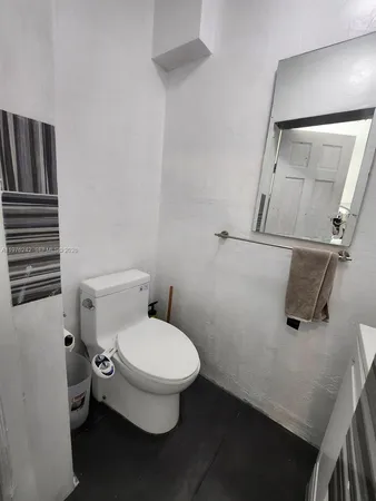 an empty room with wooden floor and wardrobe