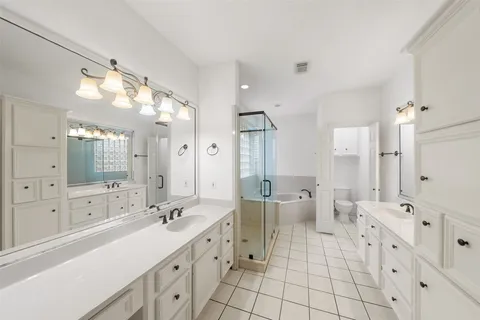a large bathroom with a double vanity sink mirror and a shower