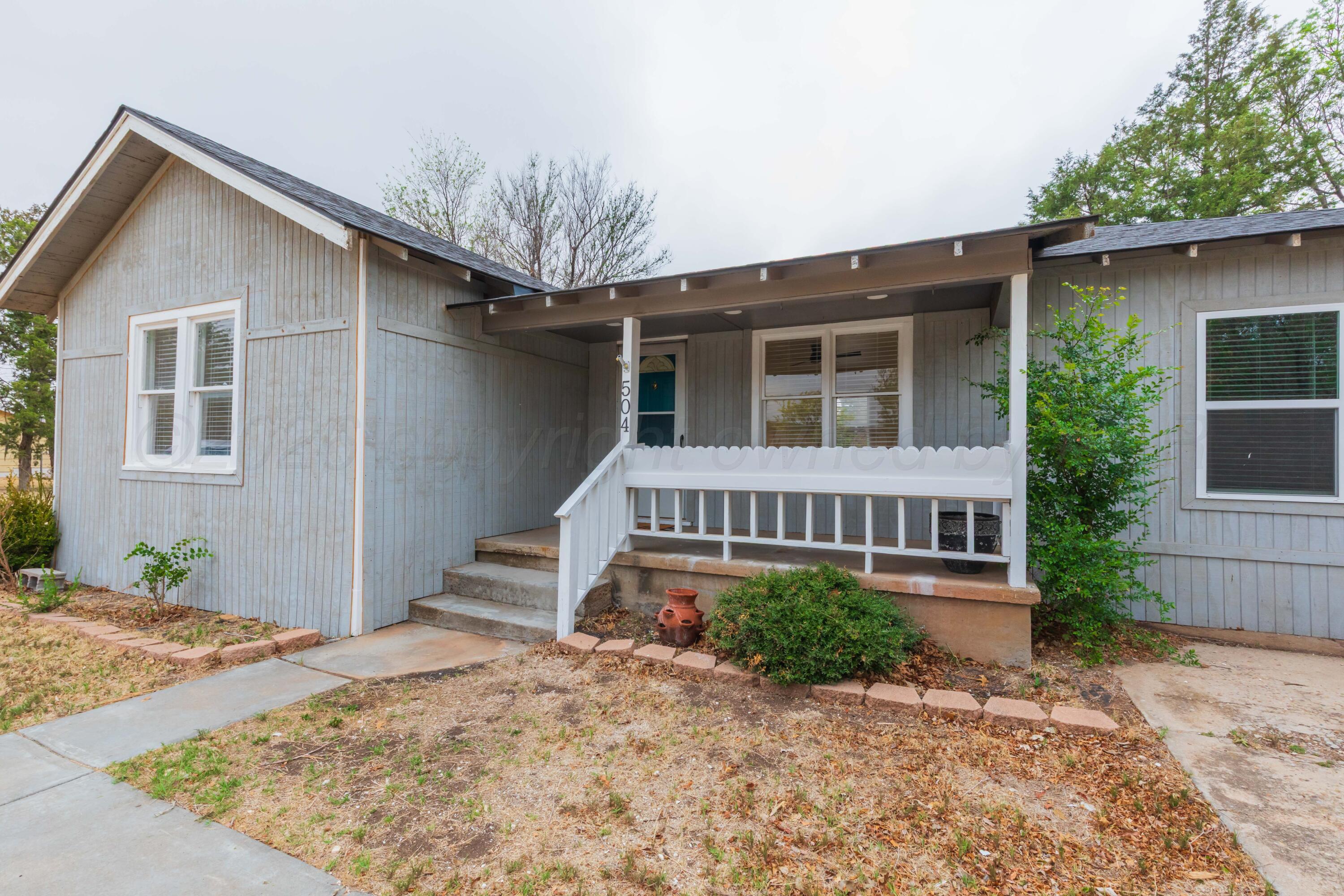 504 High Street Claude, TX 79019 - Photo 4 of 39 a view of a house with a yard and potted plants