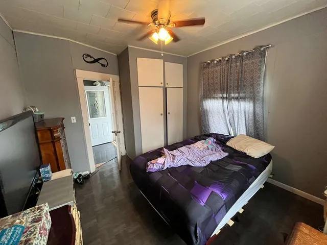 a bedroom with bed and a window