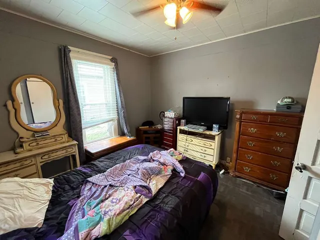 a bedroom with a bed and a television