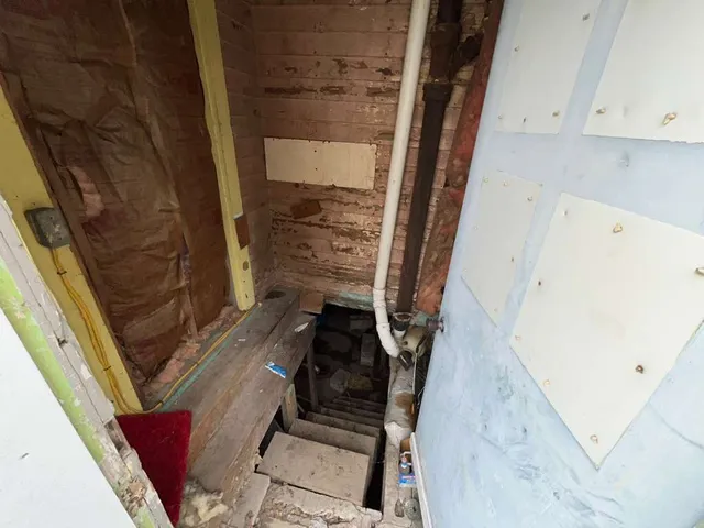 a view of living room with furniture and a fireplace