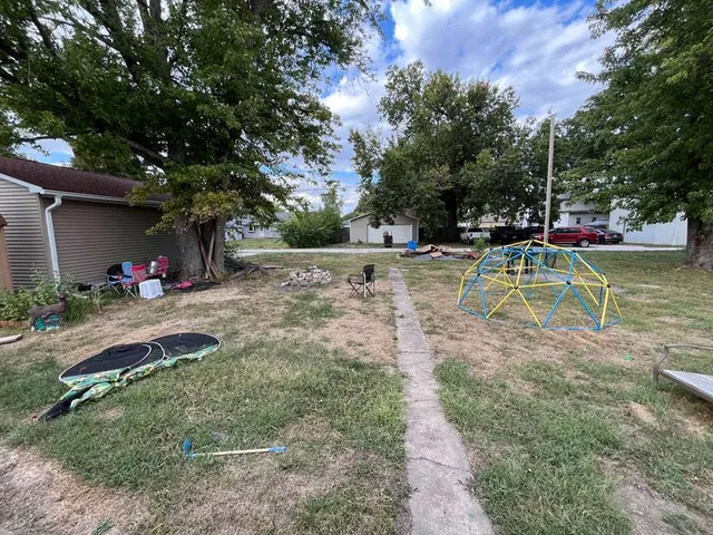a view of a backyard with large trees
