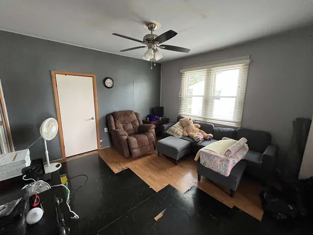 a living room with furniture rug and window