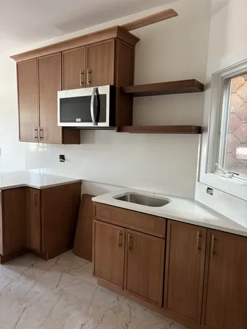 a kitchen with a sink and microwave