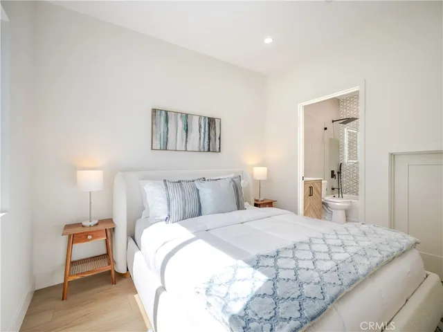 a bedroom with a bed and a lamp