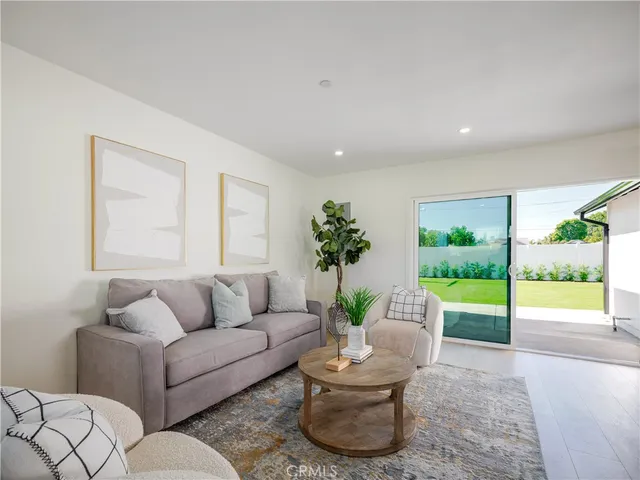 a living room with furniture and a garden