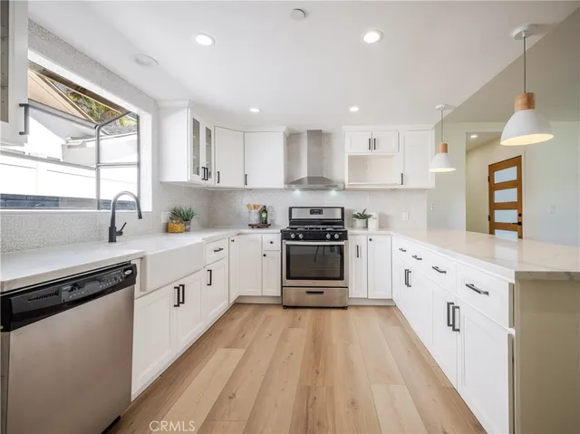 a kitchen with granite countertop white cabinets and white appliances