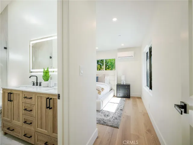 a living room with furniture a window and wooden floor