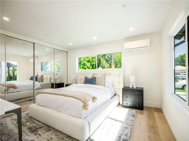 a spacious bedroom with a large bed and a couch