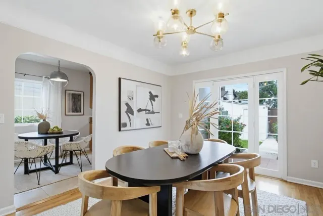 a view of a dining room with furniture wooden floor and a chandelier