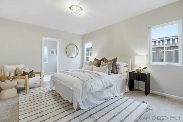 a bedroom with bed and a window