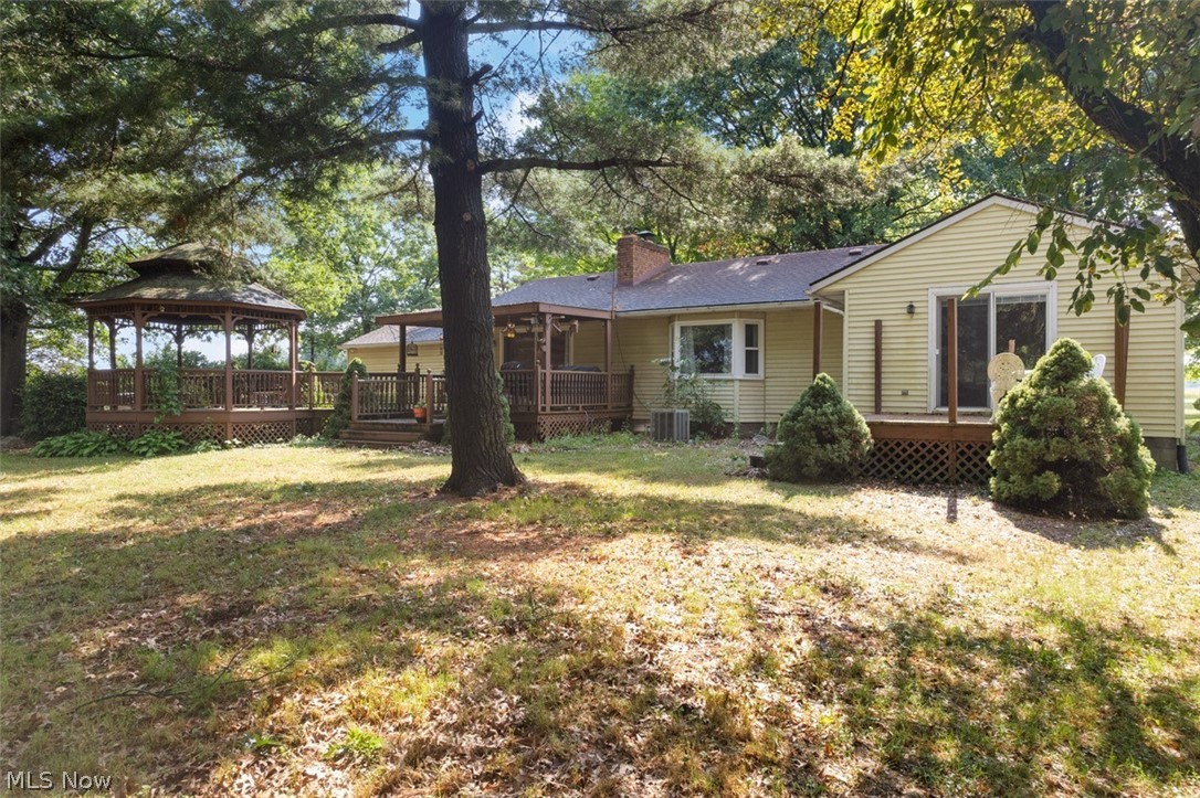 Acme Road Rittman, OH 44270 - Photo 40 of 45 Rear view of house with a lawn, central AC unit, a deck, and a gazebo