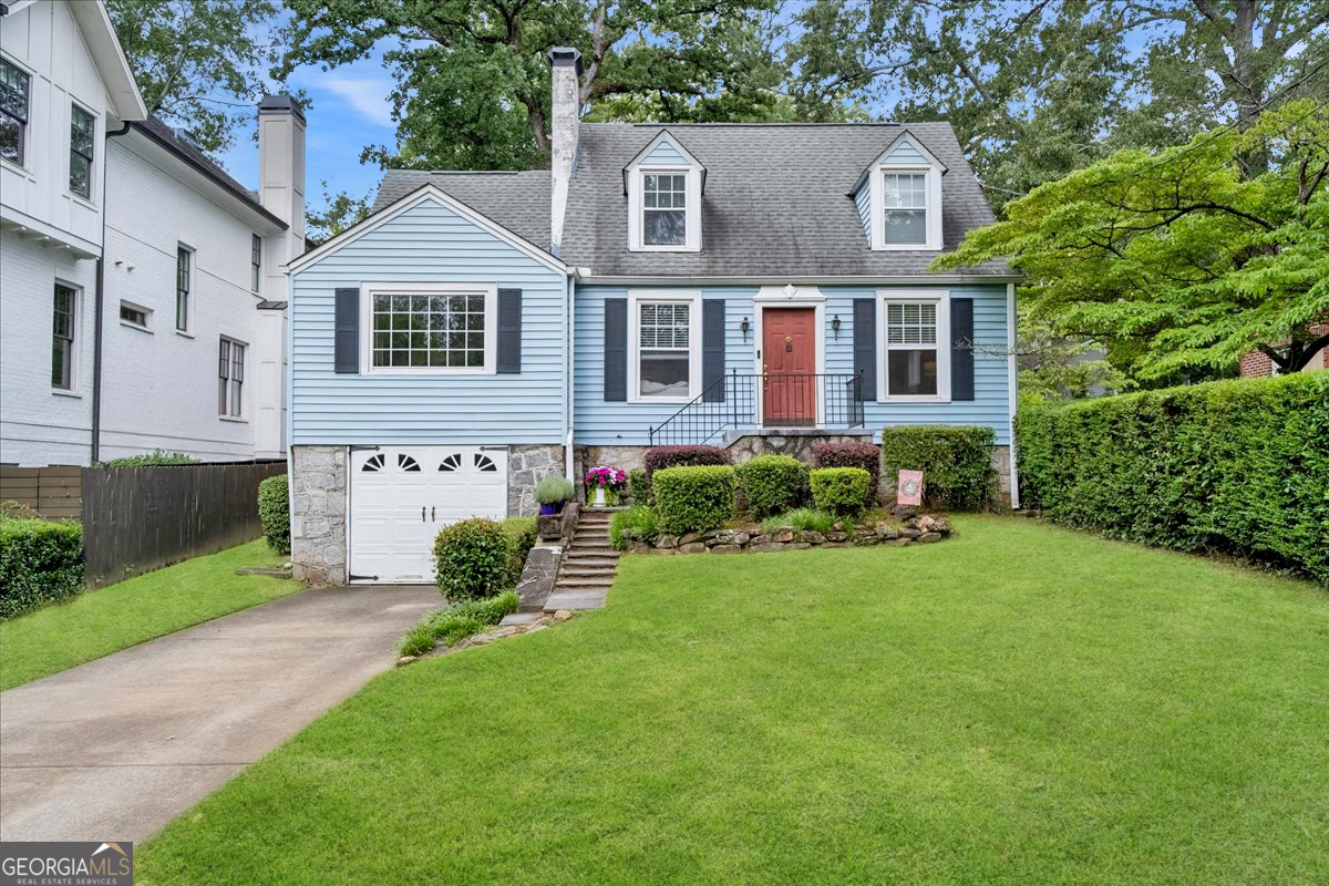 a front view of a house with garden