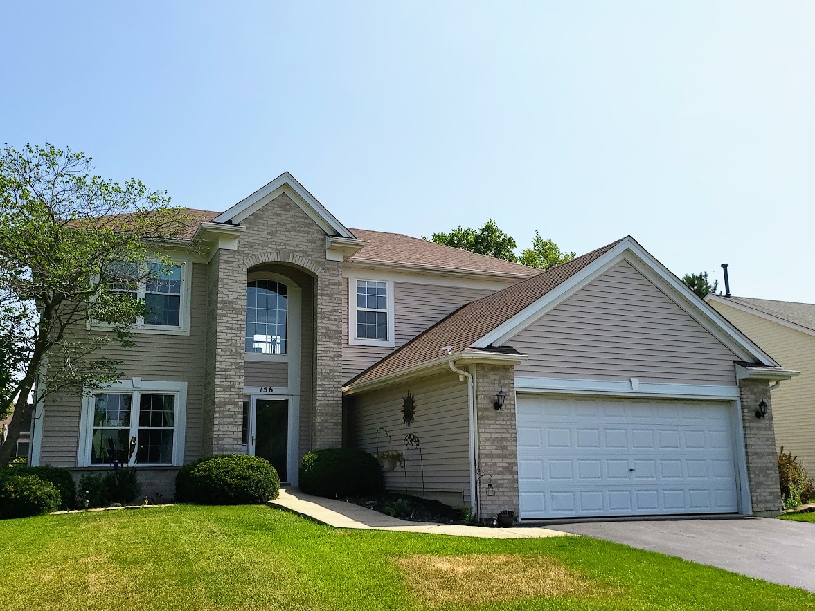 156 Sycamore Drive Bolingbrook, IL 60490 - Photo 1 of 26 a front view of a house with a garden