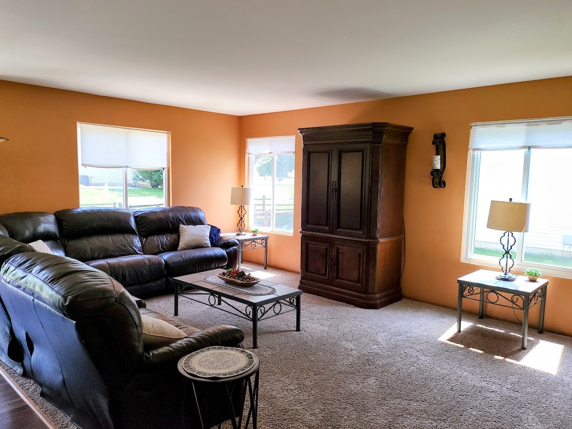 156 Sycamore Drive Bolingbrook, IL 60490 - Photo 12 of 26 a living room with furniture a window and a flat screen tv