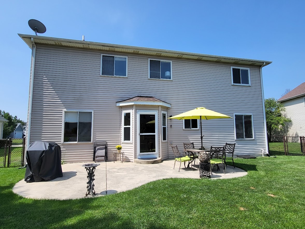 156 Sycamore Drive Bolingbrook, IL 60490 - Photo 25 of 26 a view of a house with a backyard and a patio
