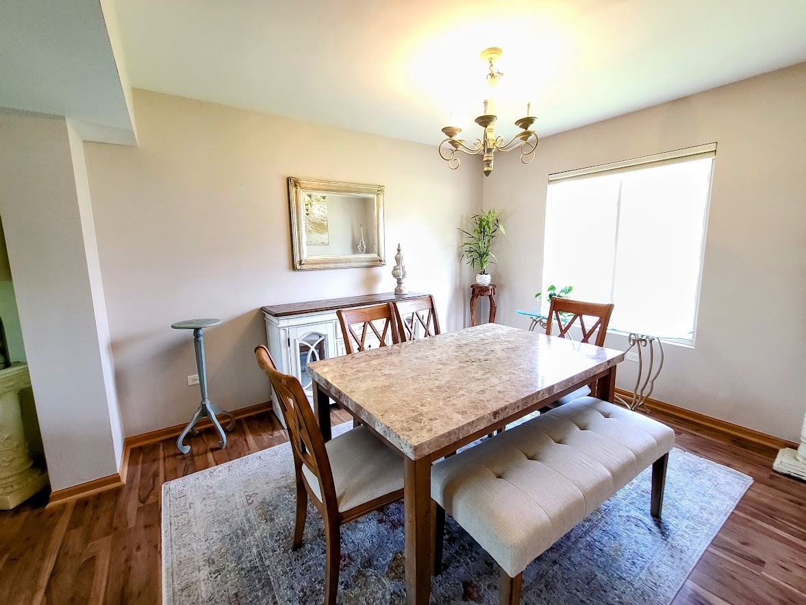 156 Sycamore Drive Bolingbrook, IL 60490 - Photo 5 of 26 a dining room with a table and chairs