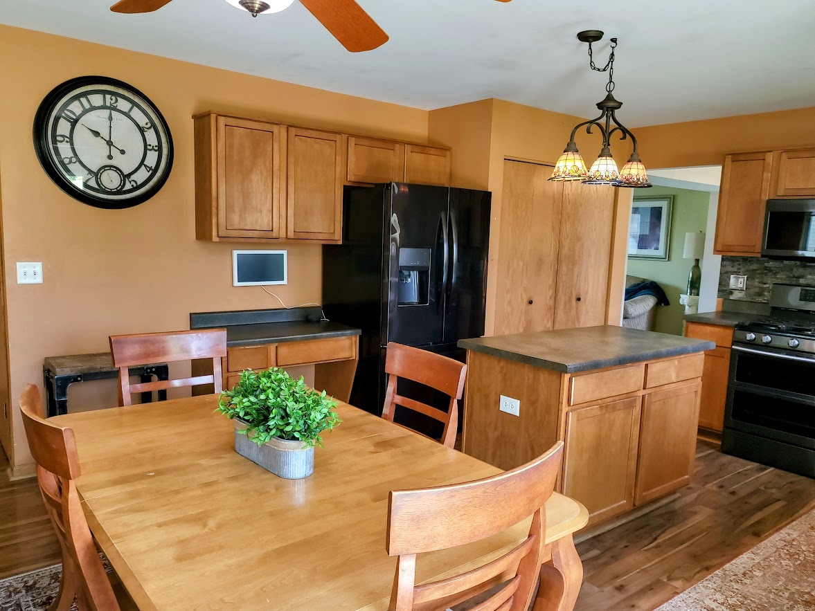 156 Sycamore Drive Bolingbrook, IL 60490 - Photo 8 of 26 a kitchen with stainless steel appliances granite countertop a stove a refrigerator a oven a dining table and chairs with wooden floor