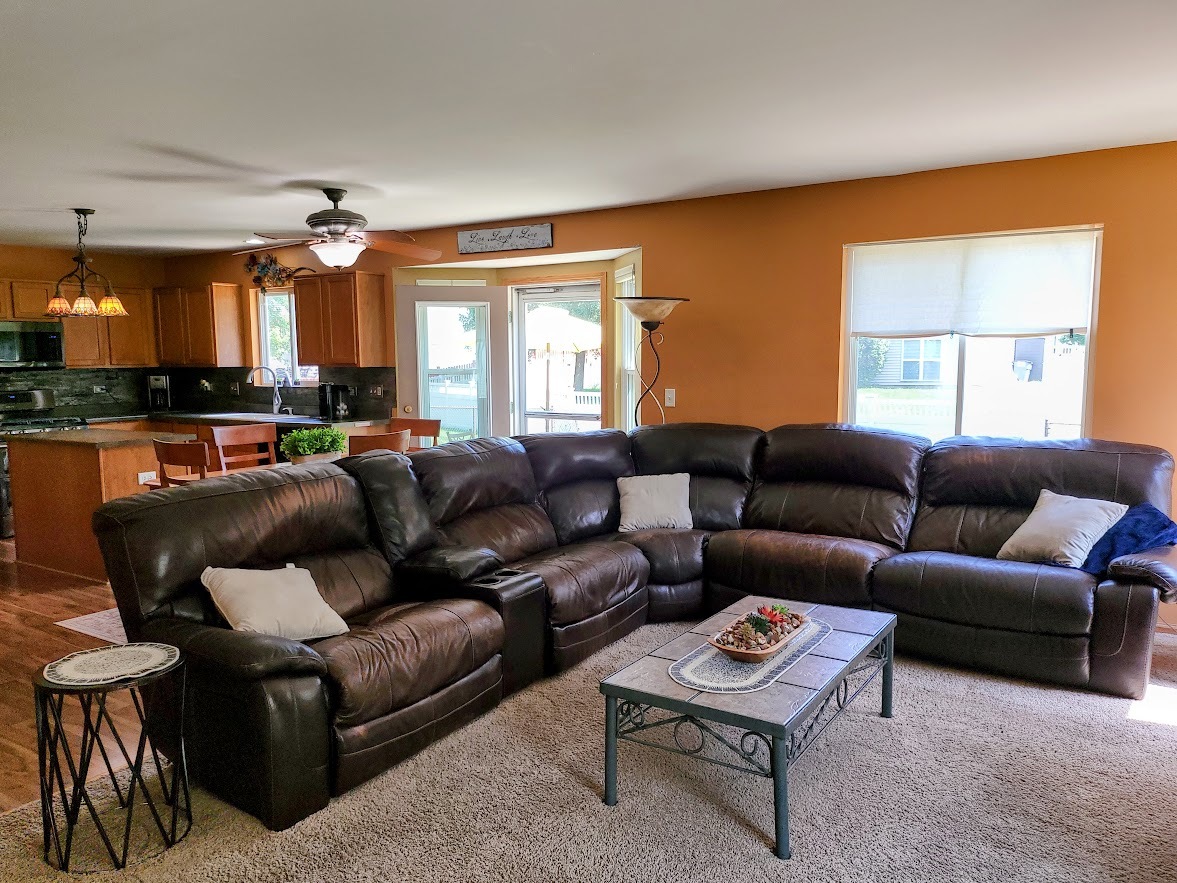 156 Sycamore Drive Bolingbrook, IL 60490 - Photo 10 of 26 a living room with furniture a ceiling fan and a window